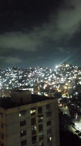 Late-night Caracas scenes captured including cityscape and young child