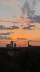 Vibrant sunset with crescent moon observed over Belgrade district