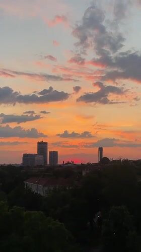 Vibrant sunset with crescent moon observed over Belgrade district