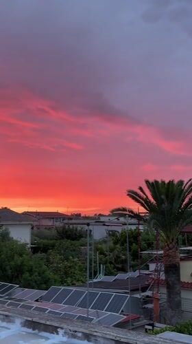 Vibrant sunset illuminates residential Aprilia, Italy on May 14