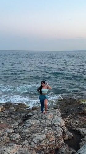 Posing on Piraeus rocks as waves roll in