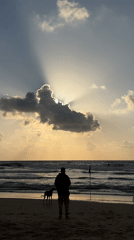 Lone beachgoer enjoys golden hour on Tel Aviv shore
