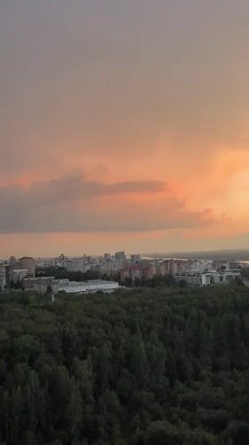 Perm at dusk: forest and city skyline from above