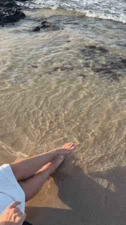 Beachgoer enjoys gentle waves at Al Fiqait shore
