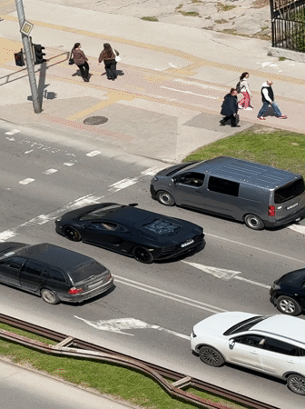 Traffic stops at light in sunny Plovdiv street scene