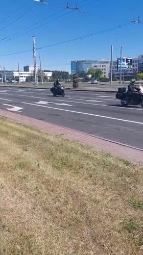 Motorcycles travel through sunny Brest streets during midday