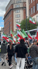 Demonstrators march with Iranian flags through Leeds streets