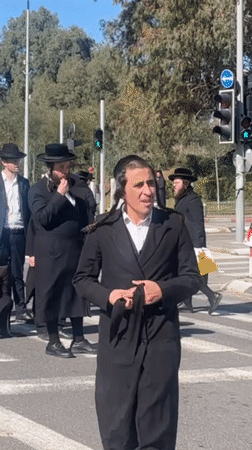 Orthodox men help fallen pedestrian at Kiryat Ono crosswalk