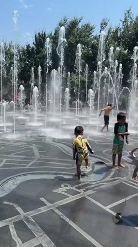 Kids cool off at Yerevan's public fountains on a summer morning