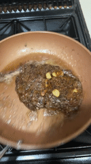 Steak and garlic searing in copper pan, South Staffordshire