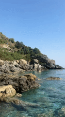 Woman sunbathes on rocky coastline in Gazipaşa, Turkey