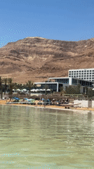 Dead Sea tourists enjoy beach relaxation and cosmetics shopping