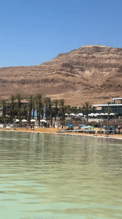 Dead Sea tourists enjoy beach relaxation and cosmetics shopping