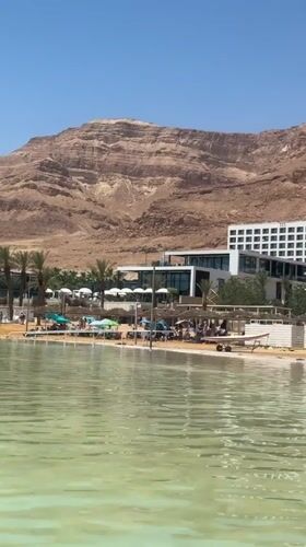 Dead Sea tourists enjoy beach relaxation and cosmetics shopping