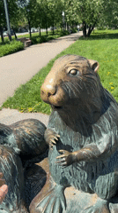 Moscow park visitors interact with bronze beaver statue
