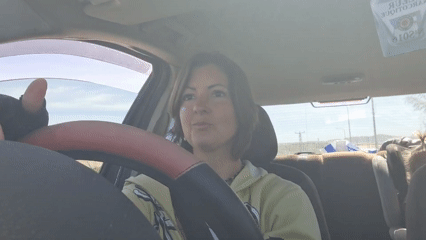 Woman with glitter, nose piercing drives in Lachish region