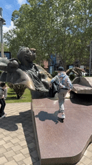 Child climbs bronze statue in Yerevan public park