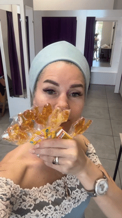 Woman with rooster lollipops films herself in Abakan store