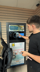 Man recycles bottle at Lidl supermarket in Blagoevgrad