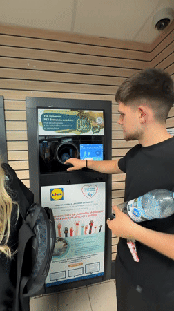 Man recycles bottle at Lidl supermarket in Blagoevgrad