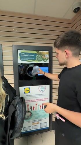 Man recycles bottle at Lidl supermarket in Blagoevgrad