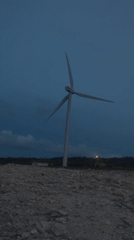 Wind turbine documented in rocky field, Phú Quý Vietnam