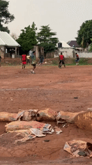 Community football match played on muddy field in Nigeria