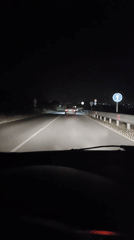 Late-night road in Ignatievo, headlights and guardrails ahead.