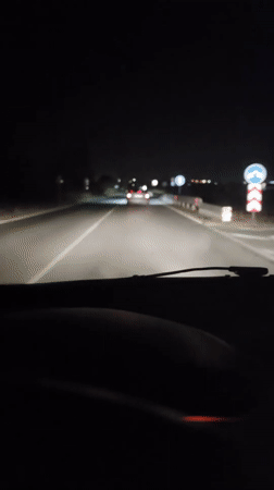 Late-night road in Ignatievo, headlights and guardrails ahead.