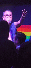 Live band performs at Denpasar venue with rainbow flag backdrop