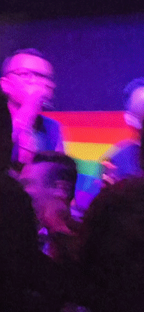 Live band performs at Denpasar venue with rainbow flag backdrop