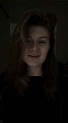 Woman observed in dimly lit indoor setting in Kazan