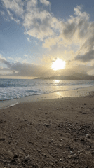 Sunset captured over Fethiye beach as waves roll ashore