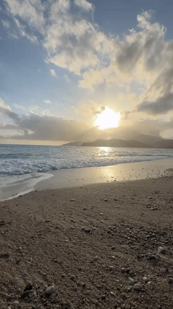 Sunset captured over Fethiye beach as waves roll ashore