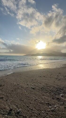 Sunset captured over Fethiye beach as waves roll ashore