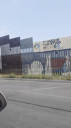 Vehicle recorded traveling alongside metal border wall in San Diego