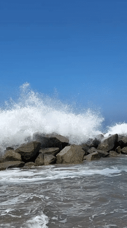 Sunny LA beach afternoon: surfers, lifeguards, and breaking waves