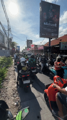 Morning rush hour traffic jams motorcycles in North Kuta