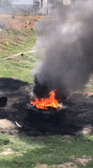 Large outdoor fire observed with dense smoke column