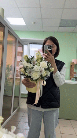 Woman poses with flower bouquet in mirror selfies, Izhevsk