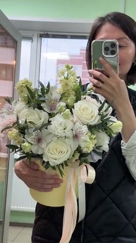 Woman poses with flower bouquet in mirror selfies, Izhevsk