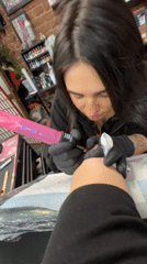 Moscow tattoo parlor session documented with artist, clients, studio