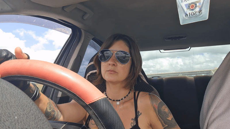 Woman with gold glitter drives through Kfar Menahem