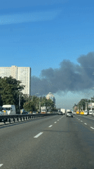 Dark smoke plume rises over Kyiv's outskirts on a clear morning