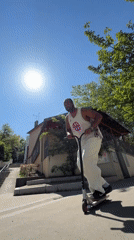 Scooter rider performs aerial trick in Lyon on sunny morning