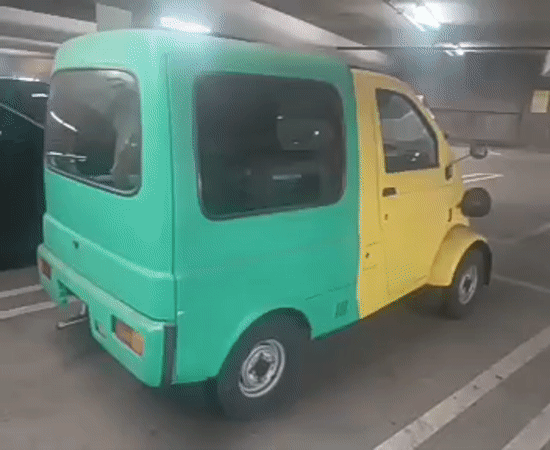 Person films distinctive green-yellow car in LA parking garage