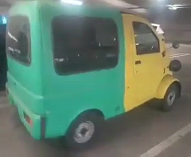 Person films distinctive green-yellow car in LA parking garage
