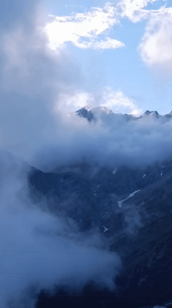 Himalayan pass life: shrines, fog, cattle, and grazing horses