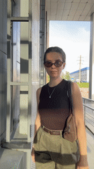 Woman takes selfies on walkway in Klin, Russia