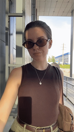 Woman takes selfies on walkway in Klin, Russia